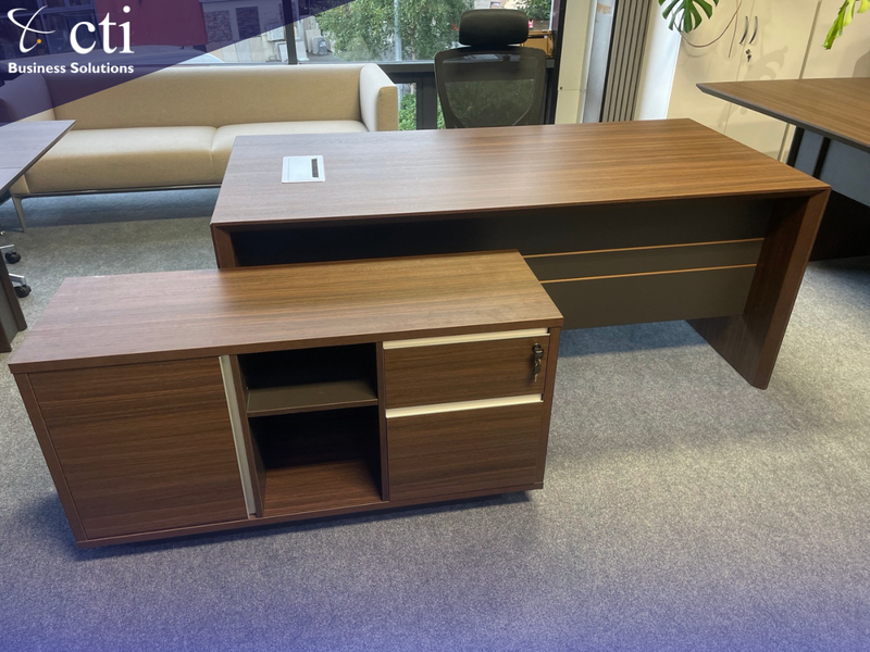 Walnut office desk with storage cabinet in an office setting, featuring the 'cti Business Solutions' logo.